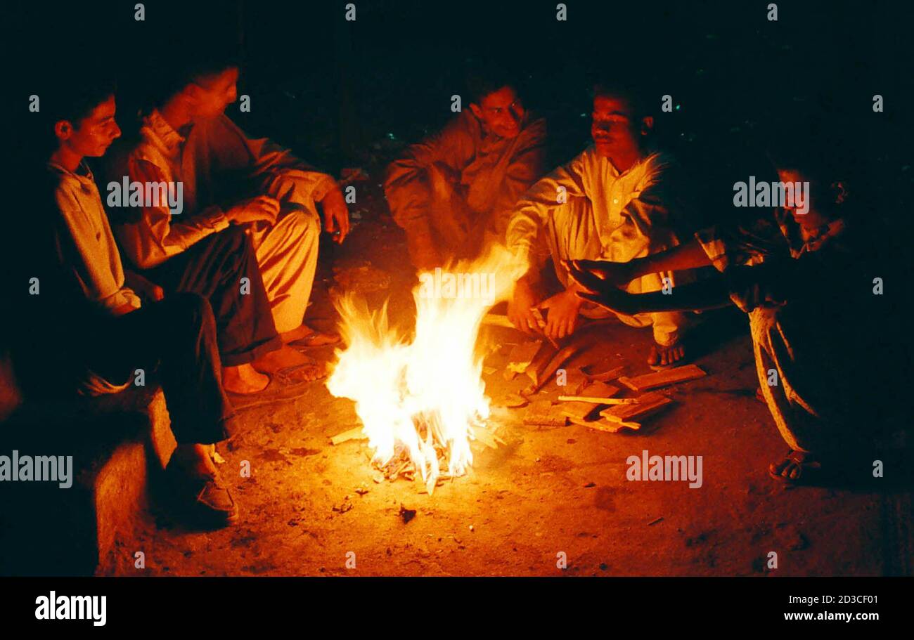 Residents Of Hyderabad City About 160 Km From Port City Of Karachi Sit Around A Fire As They Spend Their Night Under Open Sky On Early January 29 2001 People Fled Their
