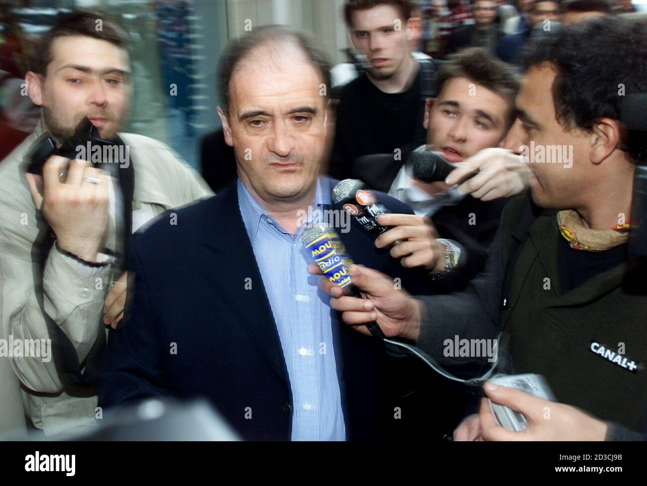 Pierre Lescure (C), dismissed French pay-TV station Canal Plus chief arrives at the Paris offices of Vivendi Universal April 17, 2002, the day after he was sacked by Jean-Marie Messier, the CEO of Vivendi Universal and owner of Vivendi's Canal Plus pay TV unit. Messier announced that Lescure would be replaced by TF1 television group senior executive Xavier Couture. Stock Photo
