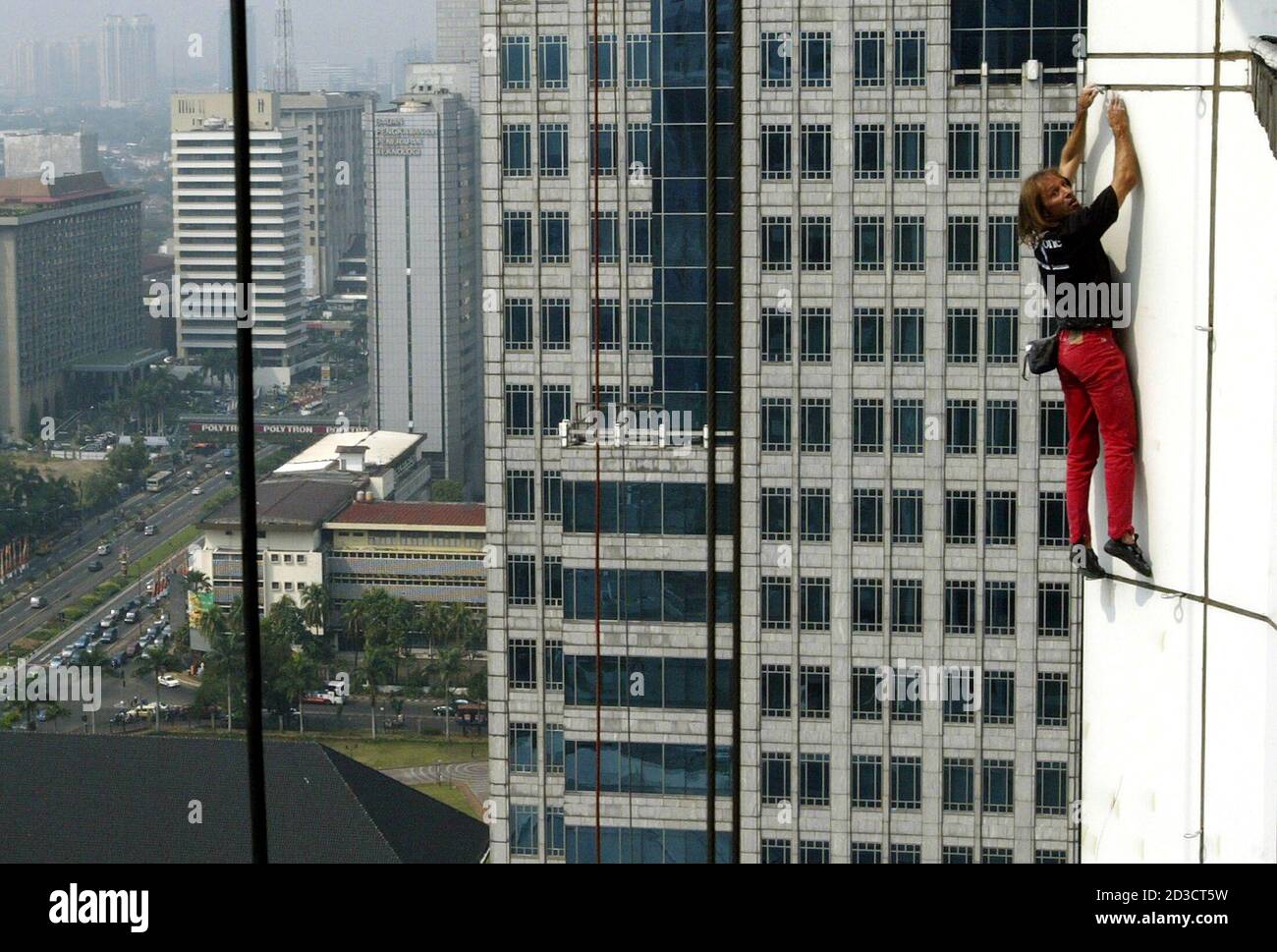 Frenchman Alain Robert A Rock Climber Who Has Become Famous For Scaling Tall Buildings Around The World Climbs The 120 Metre 394 Foot Tall Indosat Building In Jakarta July 25 2005 Alain