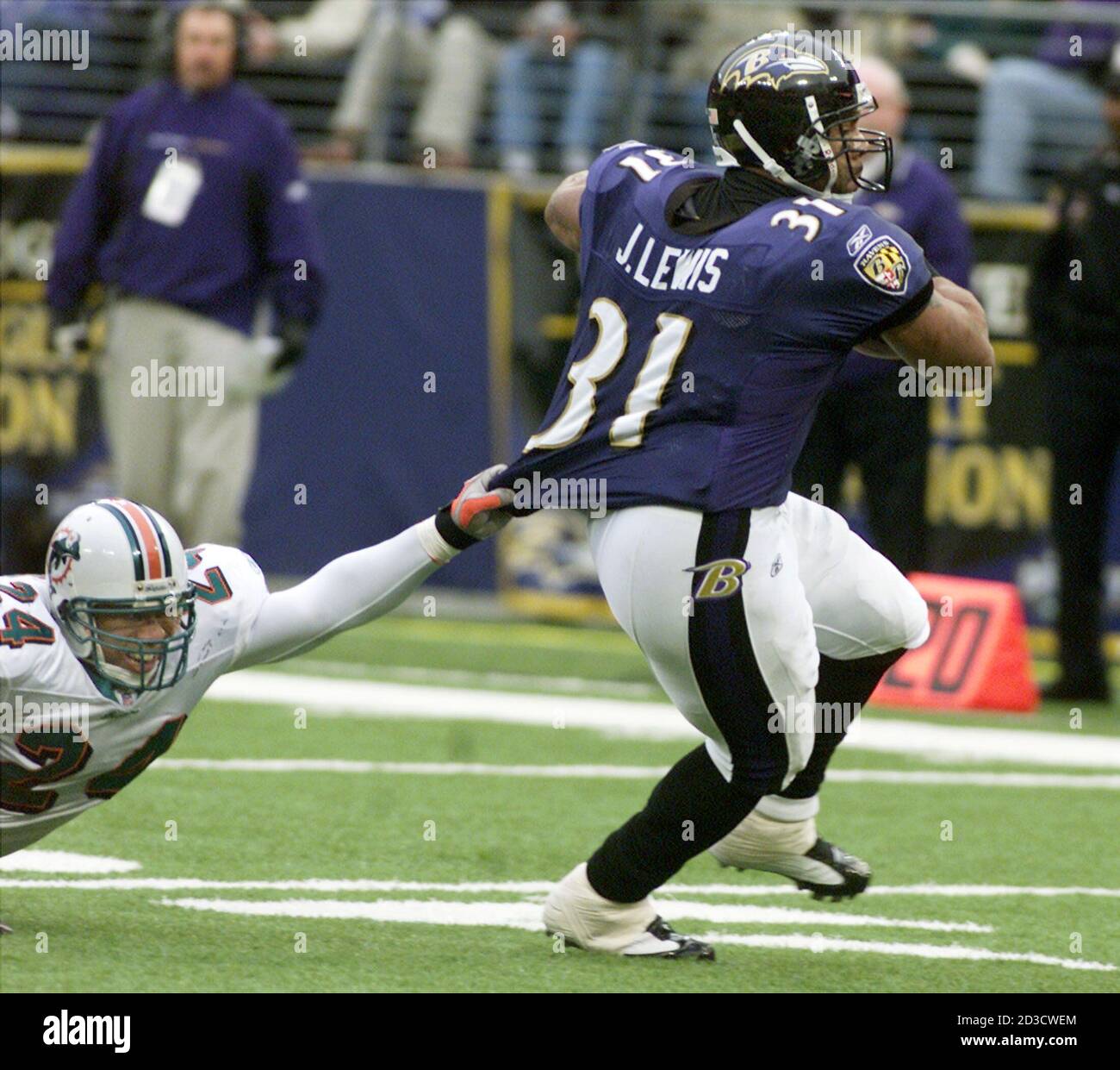 Baltimore Ravens' running back Jamal Lewis (R) picks up a first down as  Miami Dolphins' safety Sammy Knight tries to pull him down by his jersey,  during the second quarter of their