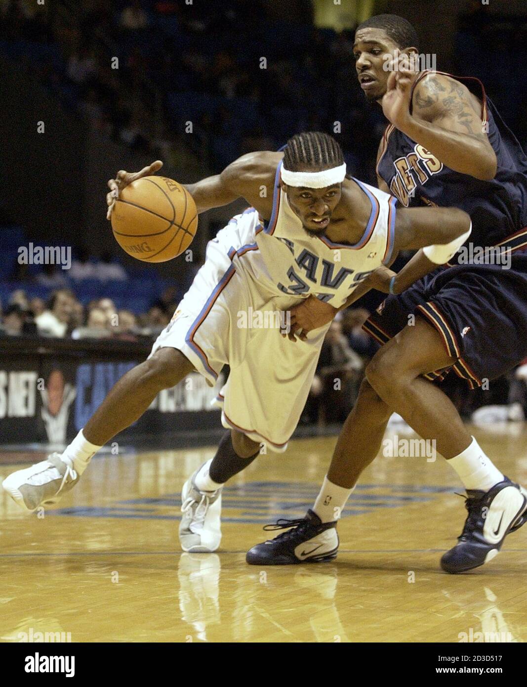 Ricky Davis (31), of the Cleveland Cavaliers, breaks toward the hoop around  Rodney White, of the Denver Nuggets, during the fourth quarter at  Cleveland's Gund Arena, December 14, 2002. The Cavs won