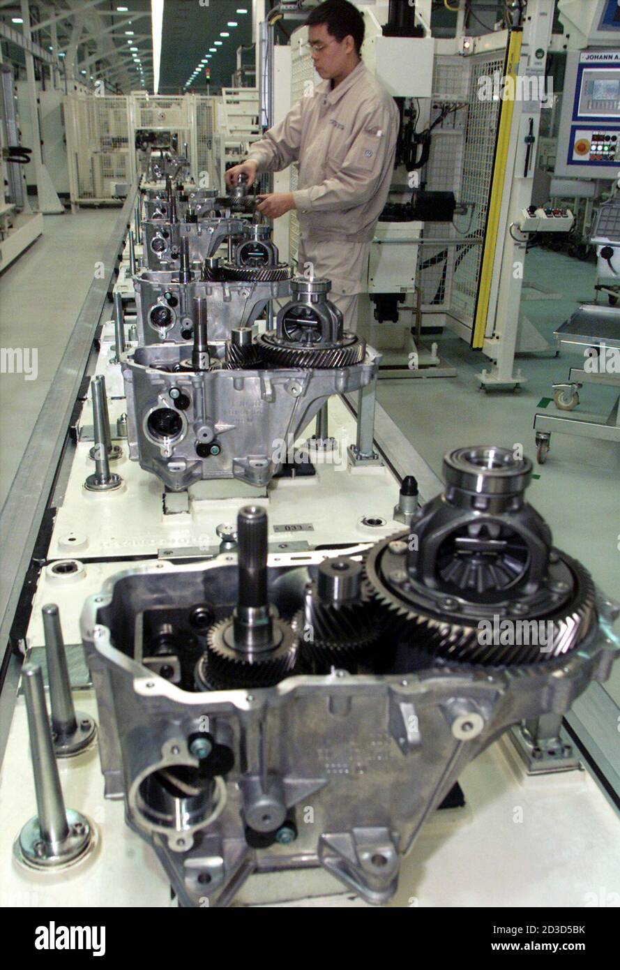 A Chinese worker assembles gearboxes at the newly built Volkswagen Transmission (Shanghai) Co. Ltd. factory in Shanghai January 28, 2003.  Volkswagen AG plans to produce 330,000 vehicles from one of its main auto ventures in China this year, up 18 percent from 2002, the German company's local partner said on Tuesday. China is already Volkswagen's second largest single market worldwide after Germany. Stock Photo