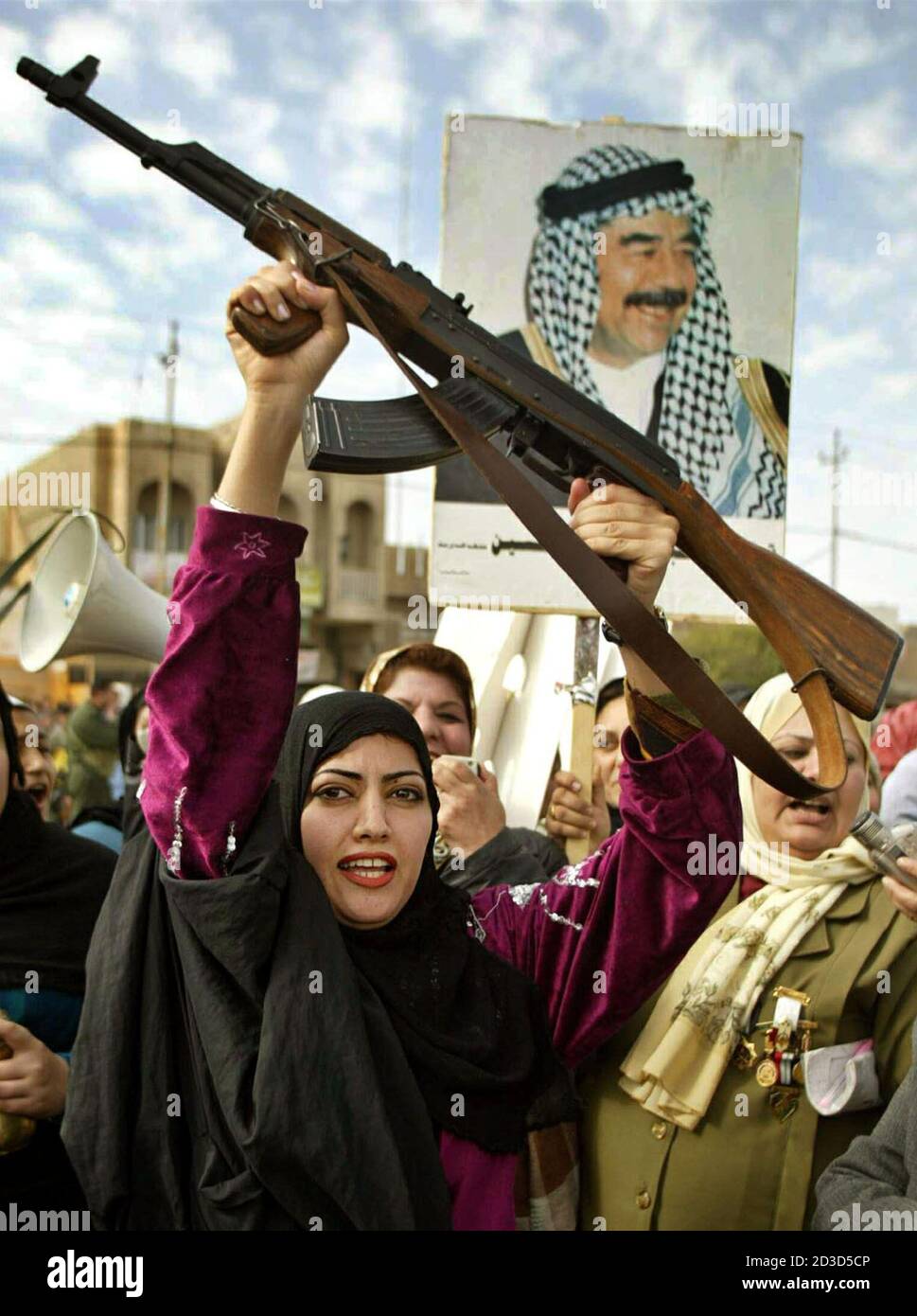 https www alamy com an iraq woman holds up an ak 47 as thousands of iraqis attend an anti us protest in the town of dora 10km south of baghdad february 2 2003 iraqi deputy prime minister tareq aziz said on saturday chief un arms inspector hans blix would go to baghdad on february 8 and rubbished us plans to expose iraqs alleged weapons of mass destruction reuterssuhaib salem sjsaa image380761718 html