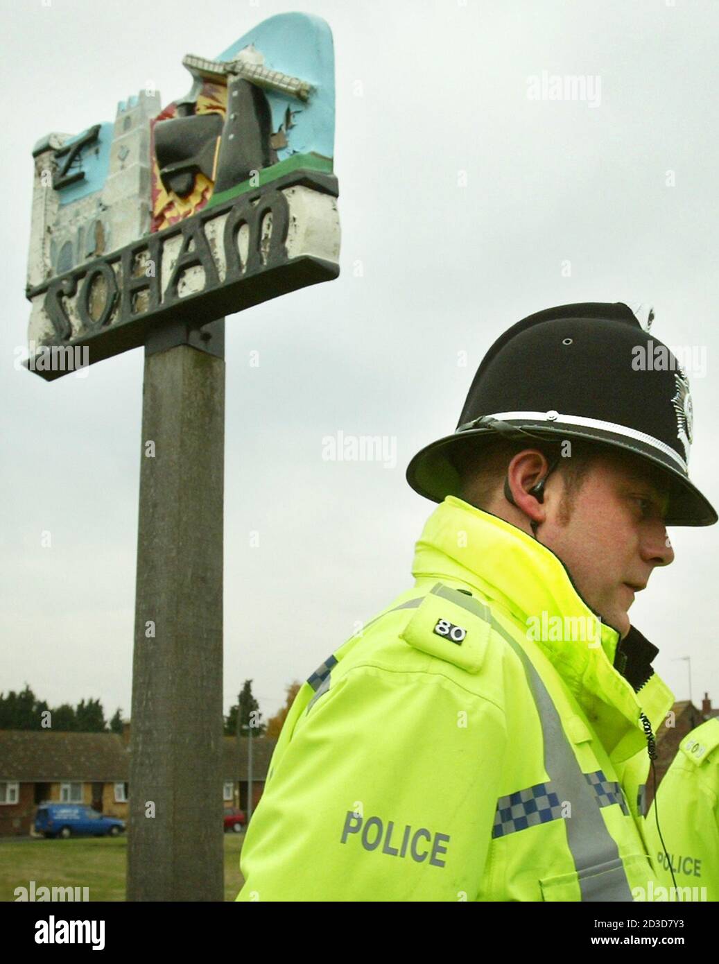 A policeman stands guard as the coach containing the jurors in the Soham murder trial is escorted by police into the Cambridgeshire town of Soham, November 10, 2003. The jury will be taken to various sites including the house at Number 5 College Close, where Ian Huntley lived and prosecutors say he murdered schoolgirls Holly Wells and Jessica Chapman last August. REUTERS/Peter Macdiarmid  JB Stock Photo