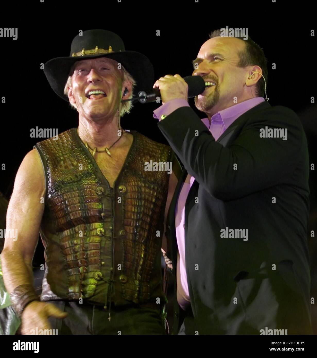 Australian singer Scott Colin Hay (L) pop band Men At performs with actor Paul Hogan, of Crocodile Dundee fame, during the closing ceremonies of the Olympic Games in Sydney