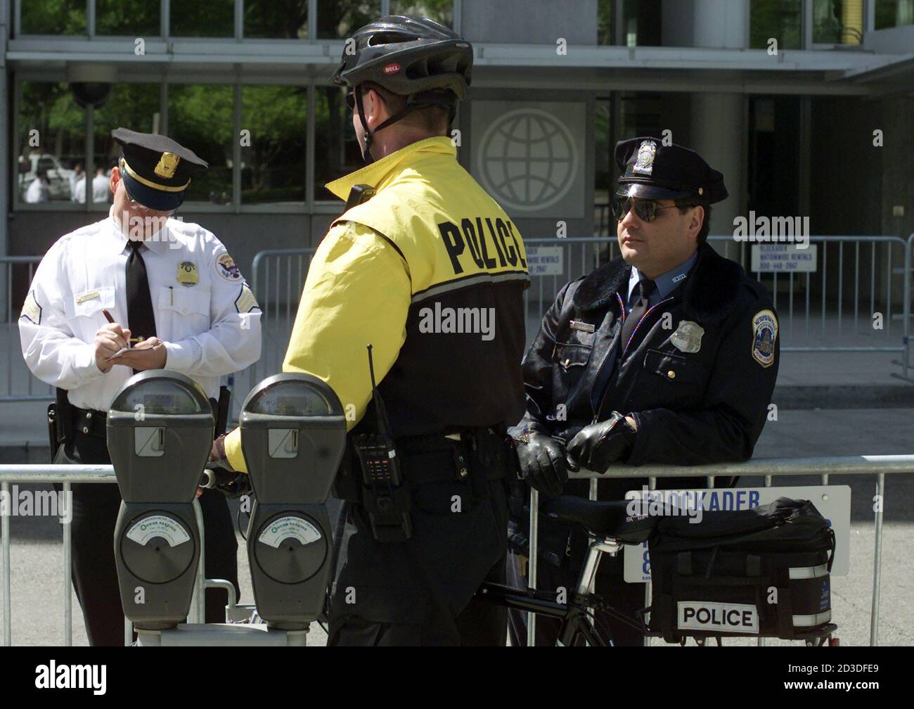 Three police officiers stand outside of the World Bank Headquarters in  Washington April 29, 2001. Police have deployed forces around two downtown  parks where protestors plan to demonstrate against the International  Monetary