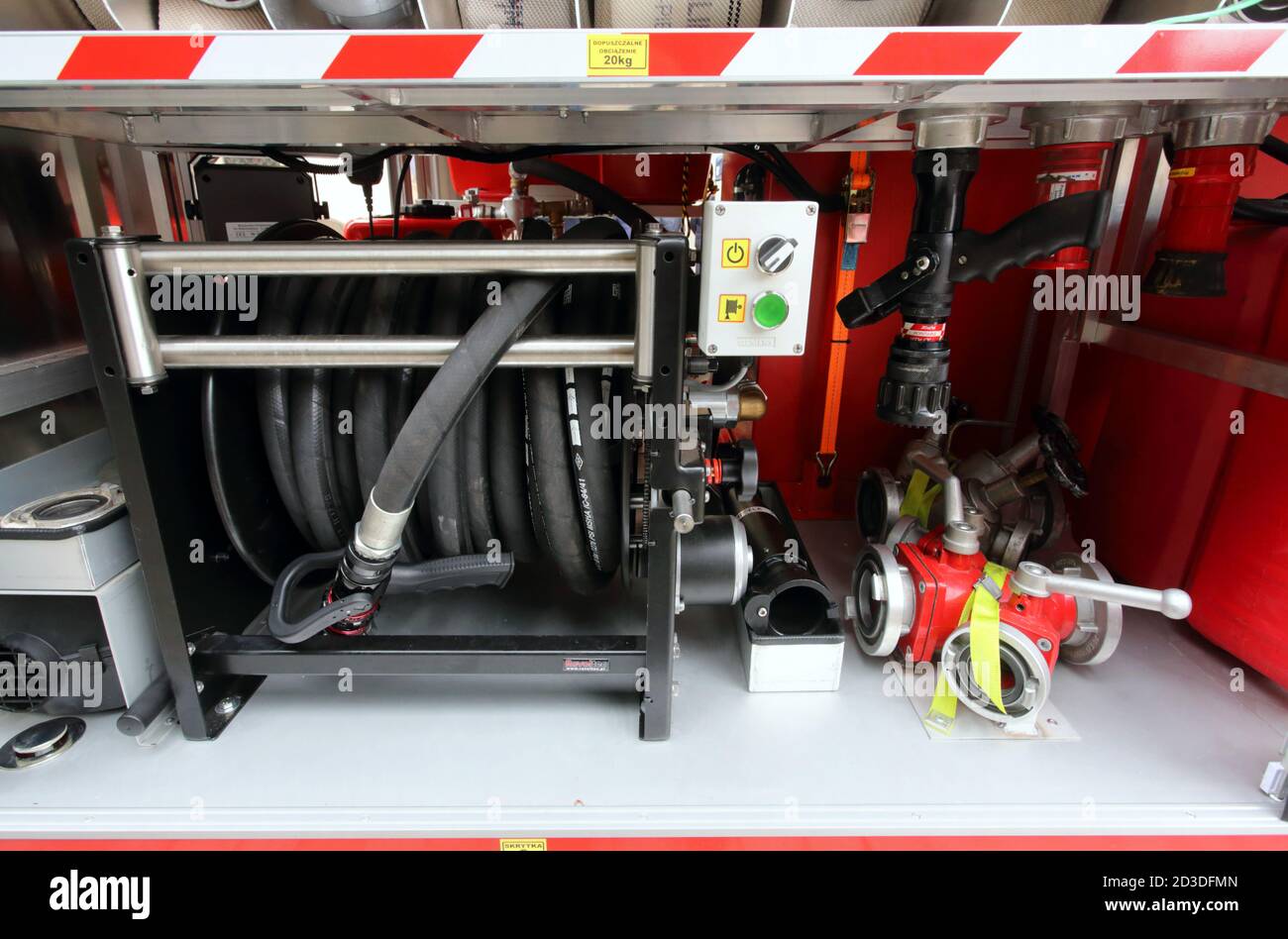 Cracow. Krakow. Poland. Three-way fire spring, rubber hose and nozzles in the fire truck storage compartment. Stock Photo