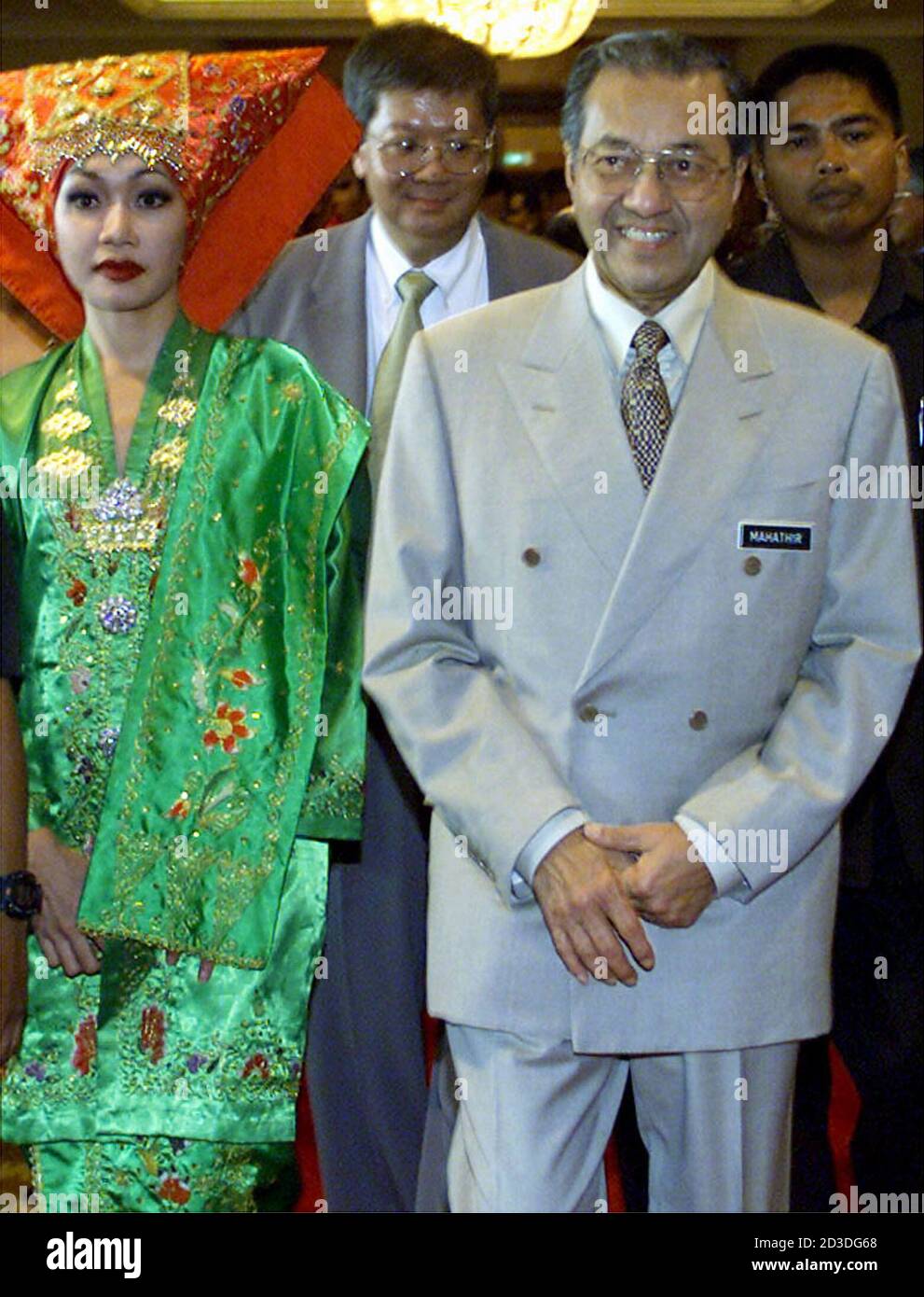 Malaysian Prime Minister Mahathir Mohamad R Is Escorted By A Woman Dressed In A Traditional Malay Costume After Opening A Seminar In Kuala Lumpur July 16 2001 Mahathir Asia S Longest Serving Elected Leader