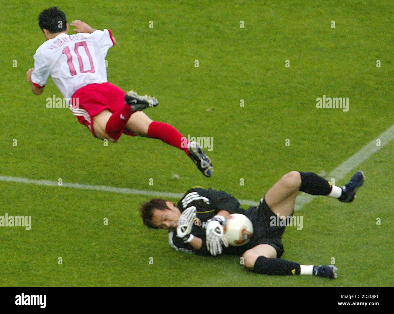 Basturk Of Turkey Flies Through The Air As Japan S Goalkeeper Narazaki Catches The Ball During Match In Sendai Yildiray Basturk Of Turkey Flies Through The Air As Japan S Goalkeeper Seigo Narazaki Catches