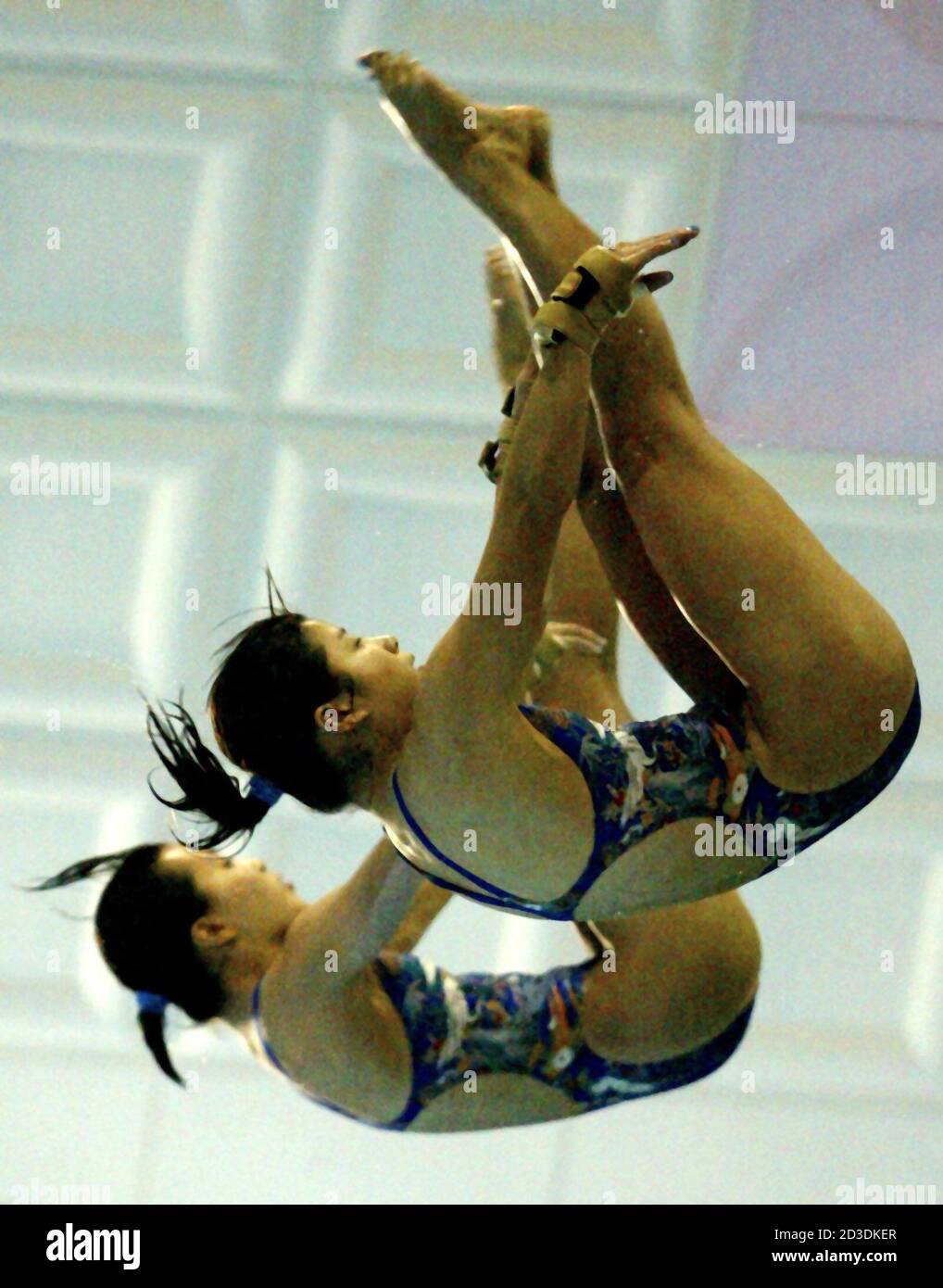 Japan's Takiri Miyazaki (front) and partner Emi Otsuki perform in the women's 10-metre platform synchronized diving final at the 14th Asian Games in Pusan, South Korea, October 9, 2002. The Japanese pair won the bronze medal behind gold medalist China and silver medalist North Korea. REUTERS/Bobby Yip  BY/JS Stock Photo