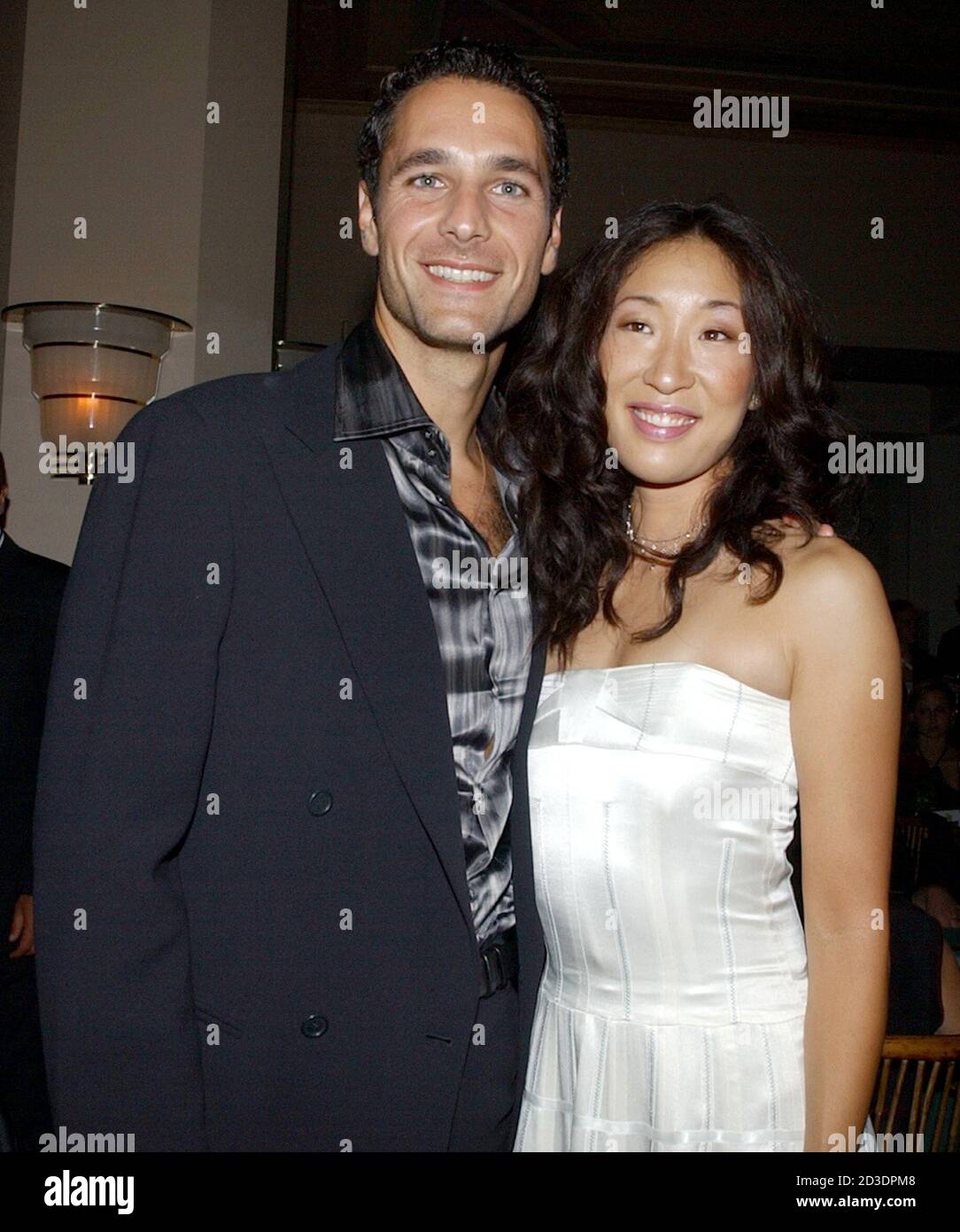 Actors Raoul Bova L And Sandra Oh Cast Members In The Motion Picture Under The Tuscan Sun Pose During The After Party Following The Premiere Of The Film In Los Angeles September