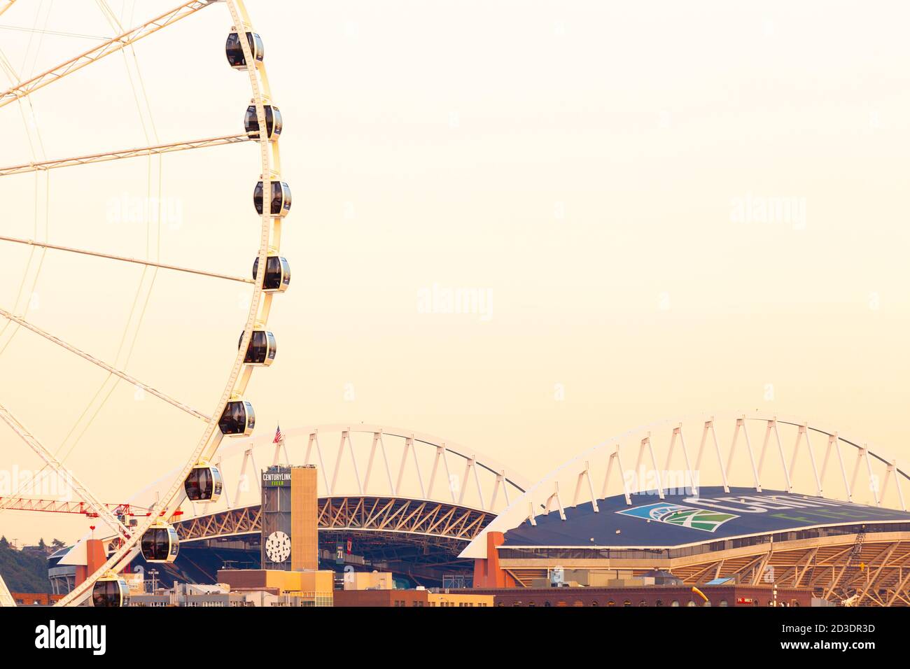 Seattle, Washington State, United States - Centurylink Field sports stadium at Pioneer Square district and Seattle Great Wheel. Stock Photo