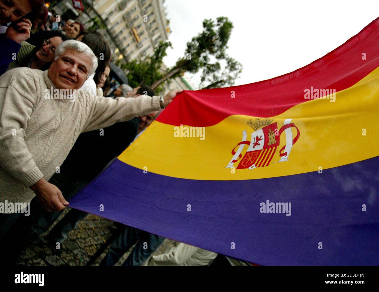 A protester shows a Spanish Republican flag during a demonstration by more than 500 anti-monarchists in Madrid, May 21, 2003, [on the eve of the wedding of Crown Prince Felipe to divorced journalist Letizia Ortiz]. Police blocked the demonstrators' access to Madrid's historic Puerta del Sol square as they waved Republican flags and chanted 'Spain, tomorrow will be Republican! Stock Photo