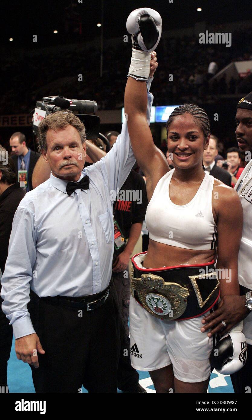 Laila Ali (R) of the United States has her arm held up by referee Robert Dixon after she defeated Monica Nunez of the United States in their IWBF super middleweight championship bout in Louisville July 30, 2004. Ali won by technical knockout. REUTERS/Peter Jones  PJ/LA Stock Photo