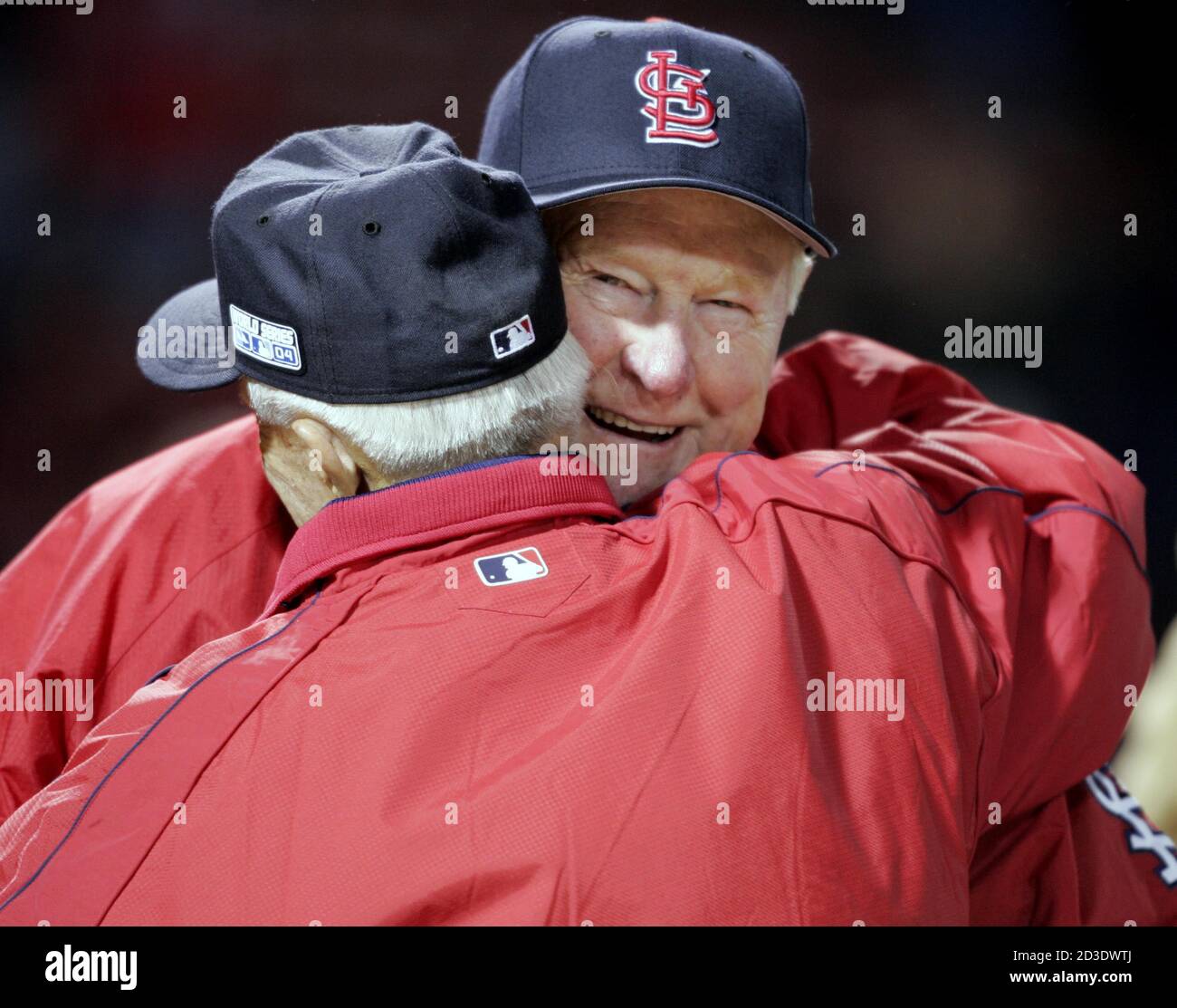 Former St. Louis Cardinals second baseman Red Schoendienst (R) embraces  former Boston Red Sox shortstop Johnny Pesky before Game 1 of the World  Series between the Sox and St. Louis Cards at