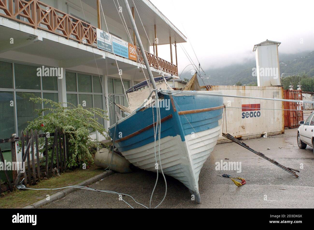 A boat lies in a road in Victoria town, Mahe Island in the Seychelles after an earthquake off Sumatra sent tsunami waves across the Indian ocean.  A boat lies in a road in Victoria town, Mahe Island in the Seychelles, following surges in the water level after an earthquake off the Indonesian island of Sumatra sent devastating tsunami waves across the Indian ocean on Sunday, in this photograph taken on December 27, 2004. Nations on the Indian Ocean from Indonesia to Sri Lanka searched amongst the wreckage of a devastating tsunami for bodies to bury on Tuesday as fears grew the toll would far ex Stock Photo