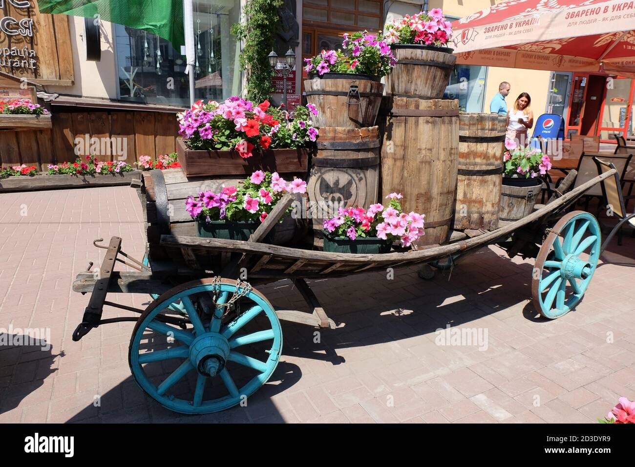 Floral display on recycled barrels tempting diners to try the pork dishes. Stock Photo