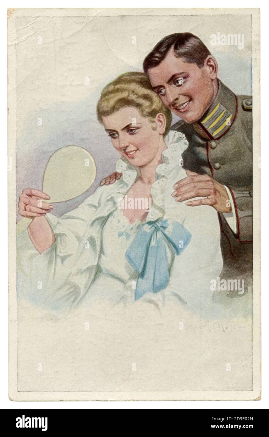 German historical postcard: a man in a military uniform admires his beautiful wife. A lady in a nightgown looks in the mirror. world war one, 1914-18 Stock Photo