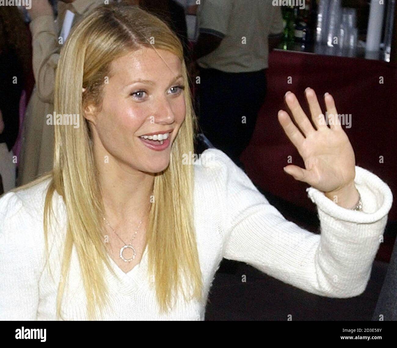 Actress Gwyneth Paltrow waves to fans as she arrives at the premiere of