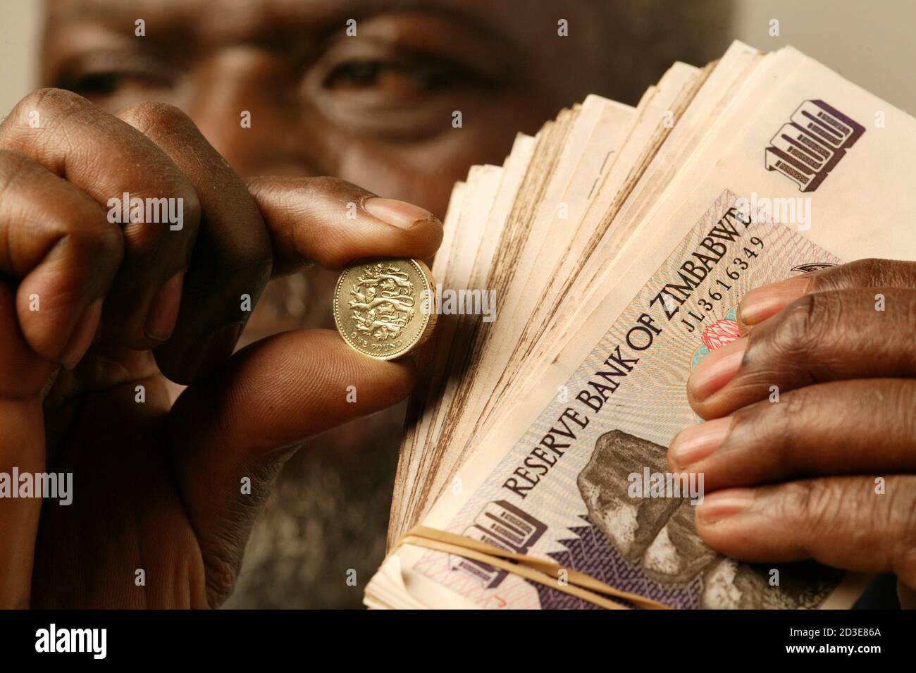 picture 1 Hundred Trillion Zimbabwe Dollars To Gbp https www alamy com a zimbabwean man holds a british one pound coin and the black market equivalent of approximately 10 thousand zimbabwe dollars september 2 2003 the zimbabwe dollar has lost its value due to hyper inflation estimated at 400 per cent there is also a critical shortage of banknotes due to the inflation with banks and building societies only handing out z 5 00000 to customers per day reutershoward burditt reuters hbas image380785842 html