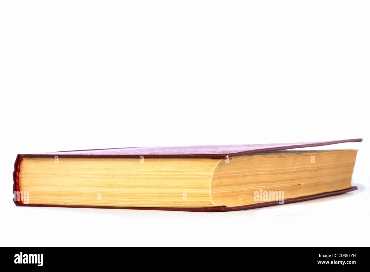one closed book isolated on white background side view Stock Photo - Alamy