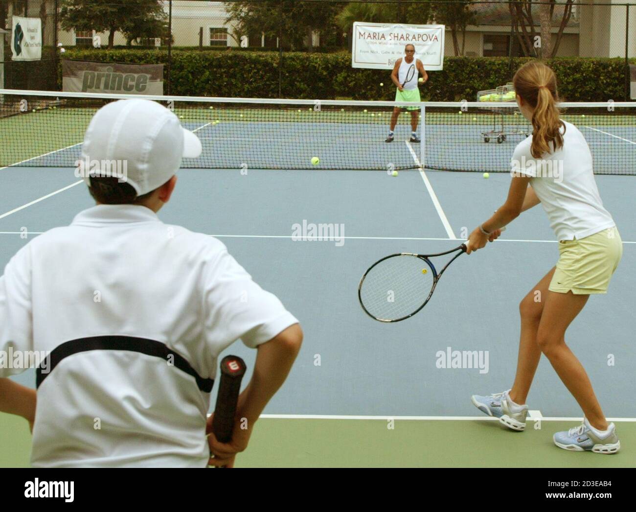 Nick Bollettieri (C) gives instructions during practice with his students  at the Nick Bollettieri Tennis Academy in Bradenton, Florida in July 12,  2004. Bollettieri Academy has trained passed champions Andre Agassi, Monica