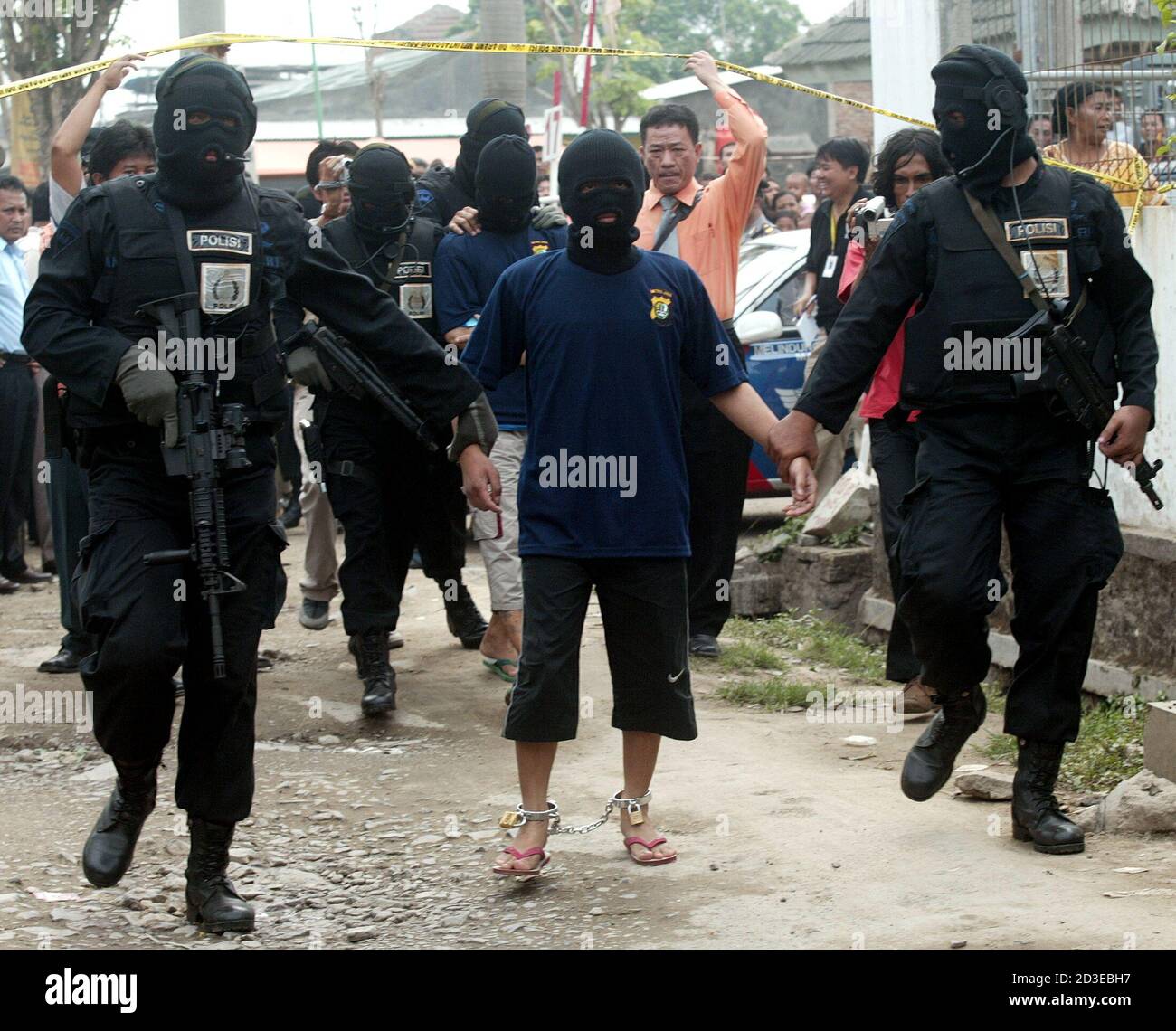 Indonesian police officers escort suspects of the Australian embassy bombing during reconstruction which showed how the bomb was transported to Jakarta from Cikande, a West Java village near Serang, 75 (