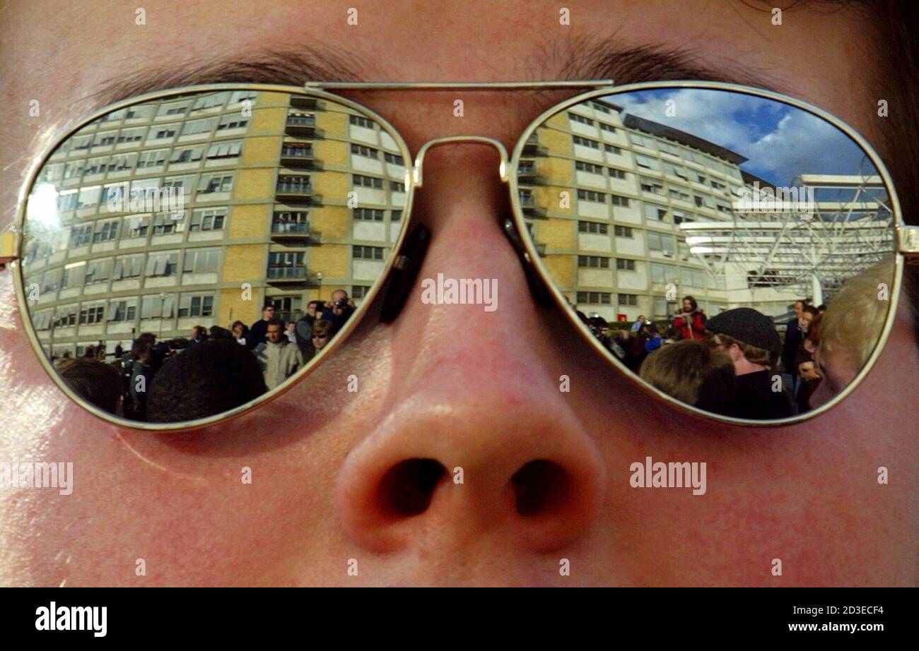The Gemelli hospital, where Pope John Paul II is being treated, is  reflected in sunglasses of a member of the Westminster school of Atalanta,  USA, as their sing outside the hospital in