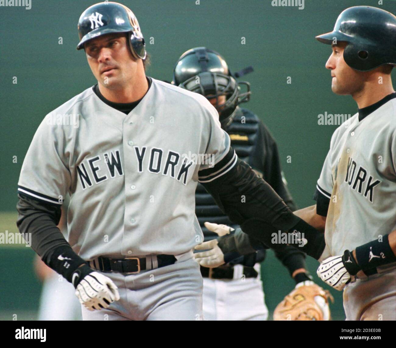 New York Yankees Jose Canseco (L) is congratulted at home plate by teammate  Derek Jeter after hitting a two run home run off of Seattle Mariners  starting pitcher Paul Abbott in the