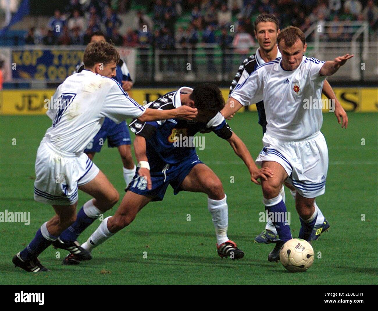 Rafik Saifi (C) of Troyes struggles with Tomas Oravec (R) and Robert  Hazucha (L) of Slovakian team Ruzomberok during their UEFA Cup first leg  match at the Aube stadium in Troyes September