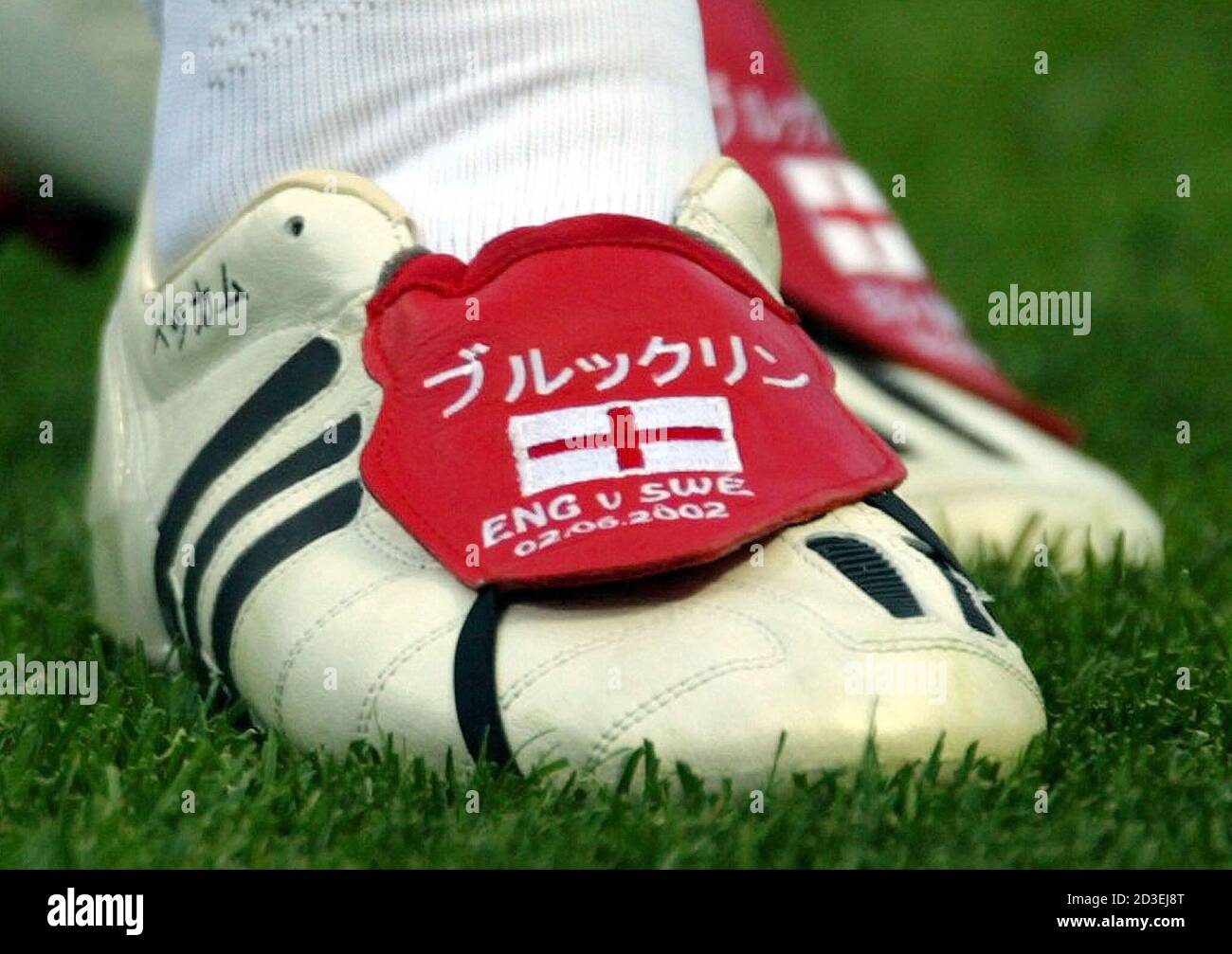 England captain David Beckham wears a pair of custom made boots for the  match with Sweden in the World Cup Finals group F in Saitama June 2, 2002.  At left is the