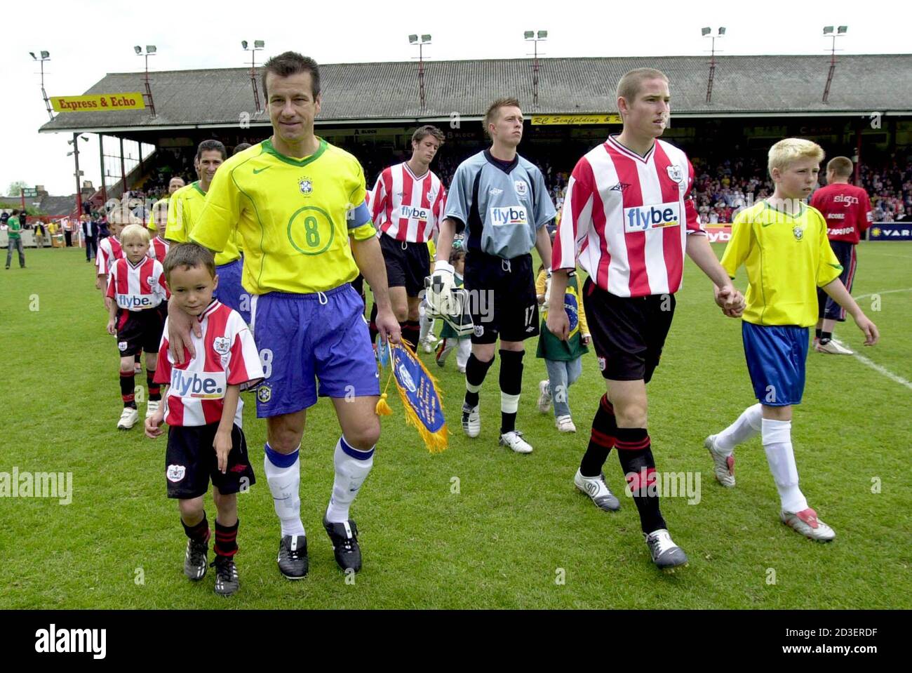 Dunga 2l Of Brazil S 1994 World Cup Winning Soccer Team And Exeter City S Glenn Cronin 2r Lead Out Their Teams And Young Mascots Before Their Friendly Match At The St James Park Ground