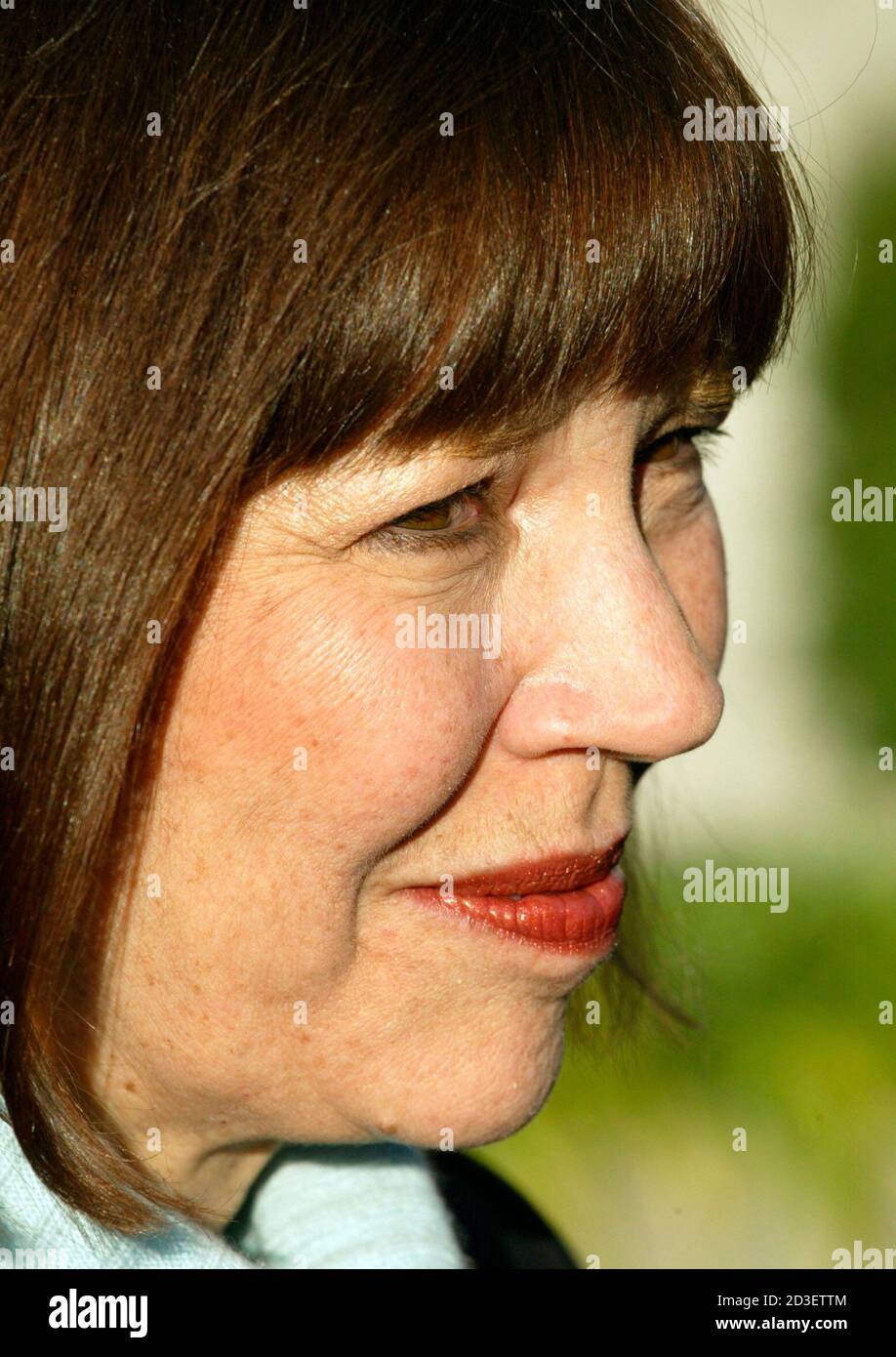 New York Times reporter Judith Miller smiles after she and Time Magazine reporter Matthew Cooper's appearance at the U.S. Court of Appeals for the District of Columbia in Washington, December 8, 2004. Cooper and Miller are two reporters facing up to 18 months in jail for refusing to testify about their contacts with confidential sources relating to the story about the unnamed Bush administration sources about the release of the name of CIA official Valerie Plame to the media 16 months ago. REUTERS/Yuri Gripas  YG Stock Photo