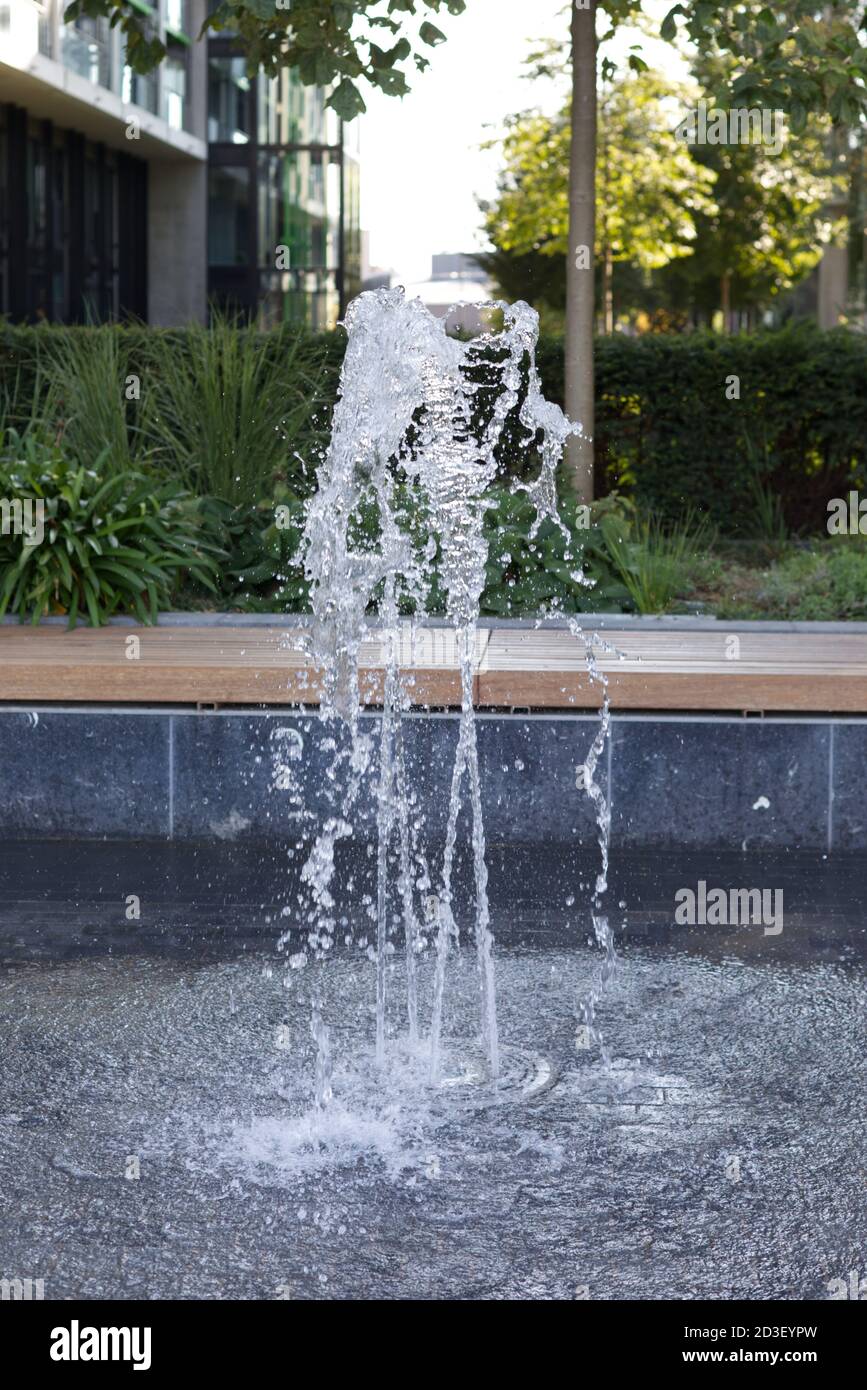 fountain of water in an inner city garden Stock Photo