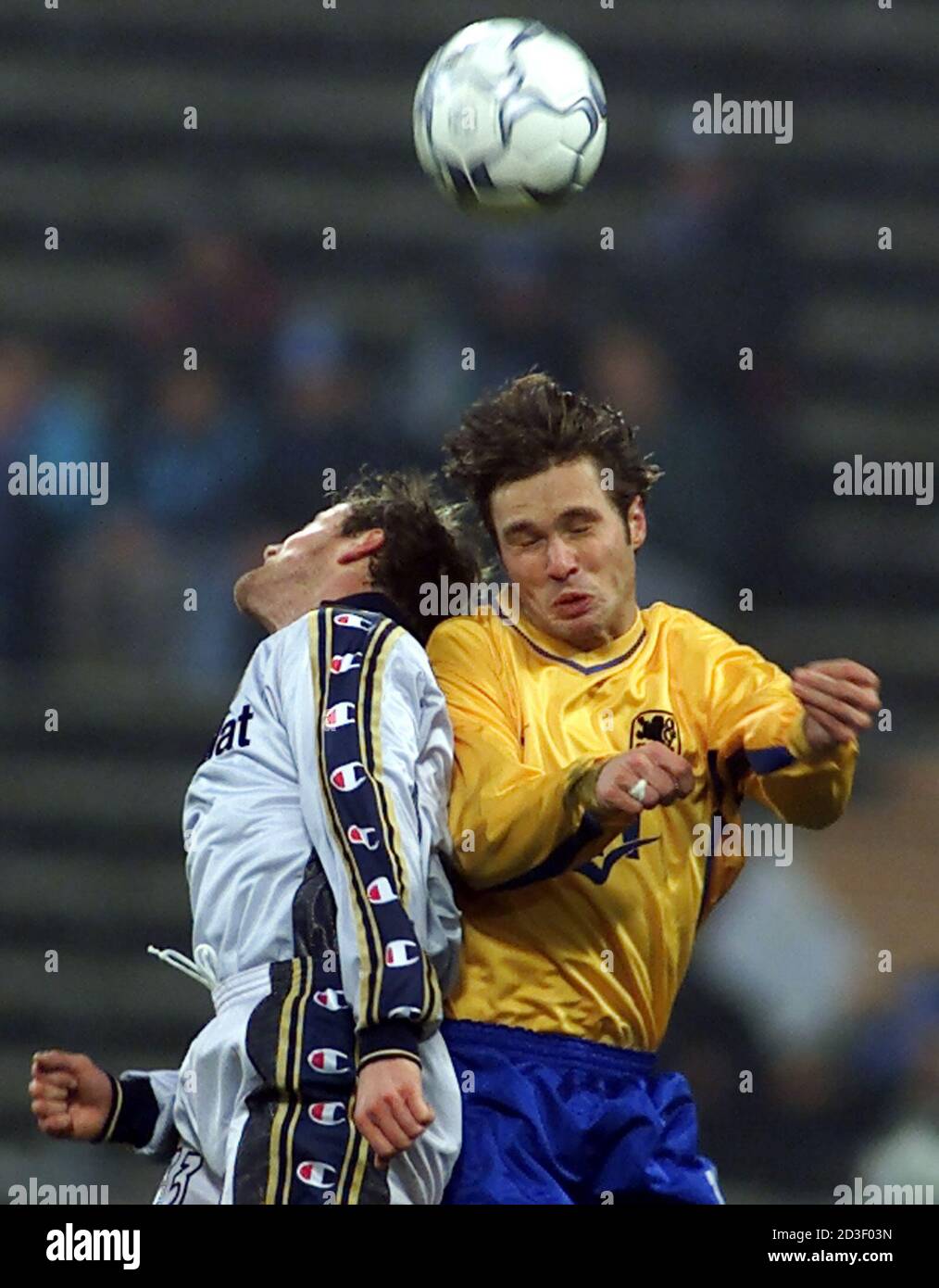 Harald Cerny (R) of TSV 1860 Munich challenges Gianluca Falsini of AC Parma during their third round second leg UEFA Cup soccer match in Munich's olympic stadium, December 5, 2000. Parma won the match 2-0.  MAD Stock Photo