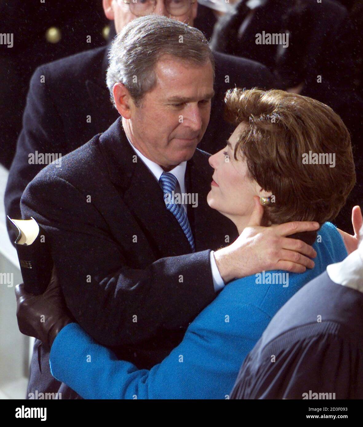 George W. Bush hugs his wife Laura after taking the oath of office to become the 43rd president of the United States in Washington, January 20, 2001. Bush pledged he would work to build 'a single nation of justice and opportunity. Stock Photo