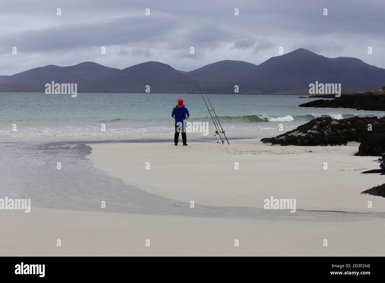 Man fishing at Luskentyre Beach on the west coast of The Isle of Harris, Scotland. Stock Photo