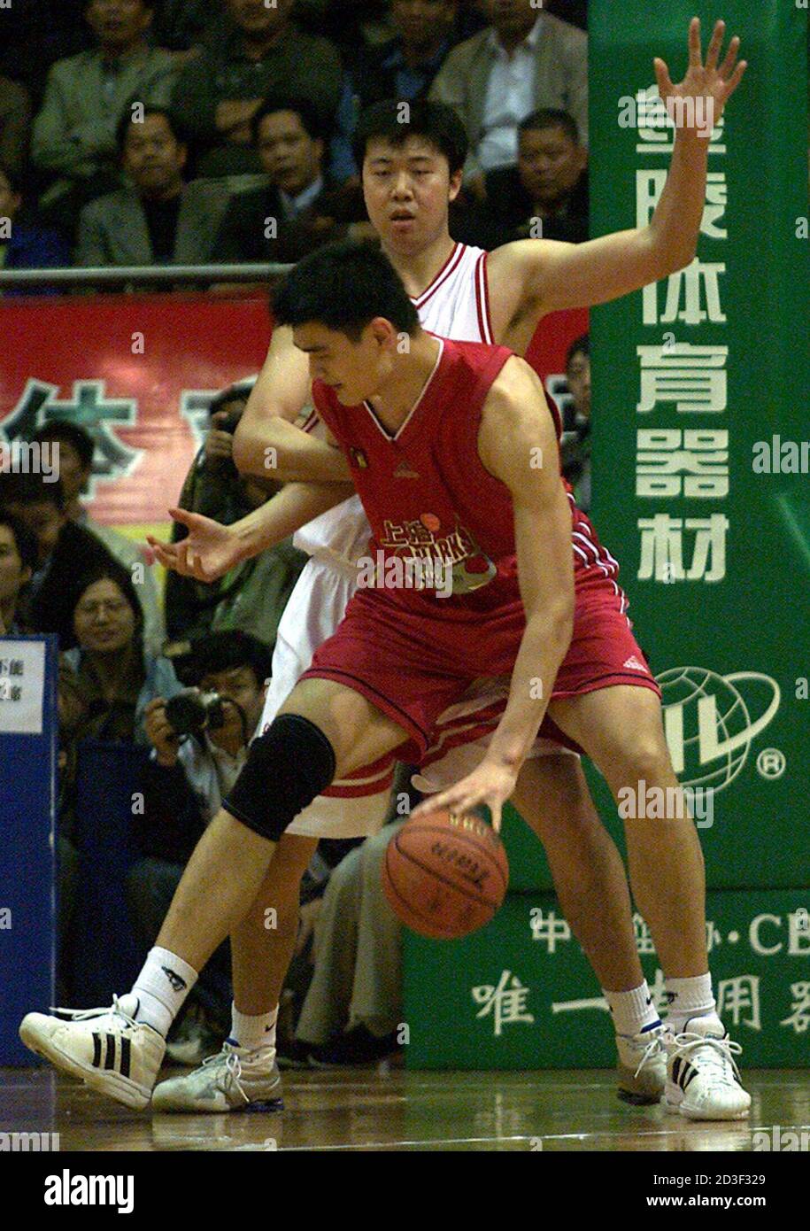 YAO MING IS GUARDED BY WANG ZHIZHITHE AT MEN'S BASKETBALL FINAL AT THE 9TH  NATIONAL SPORTS GAMES IN DONGGUAN. Shanghai's Yao Ming (F) is guarded by  the People's Liberation Army's Wang Zhizhi,