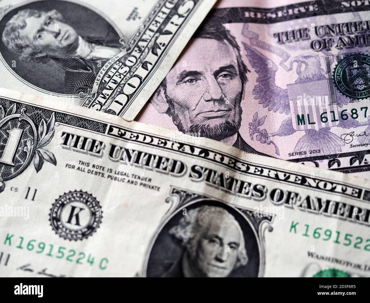 A photo illustration of US various dollar bills ibackground. Selective focus. 1 dollar bill at