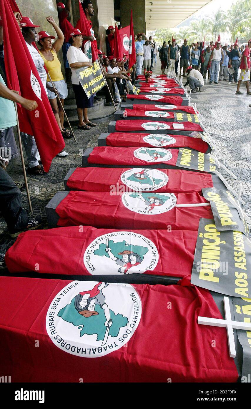 A member of Brazil's Landless Movement (MST) chant slogans next to coffins during a demonstration in Rio de Janeiro April 16, 2004, marking the eighth anniversary of a police massacre of 19 rural workers. Landless workers, trade unions and Roman Catholic Church groups have called for a day of protests to remember those killed in the 1996 massacre in which police opened fire on farmers demanding land in the remote in Eldorado dos Carajas, Northeastern Brazil. REUTERS/Sergio Moraes  SM/HB Stock Photo