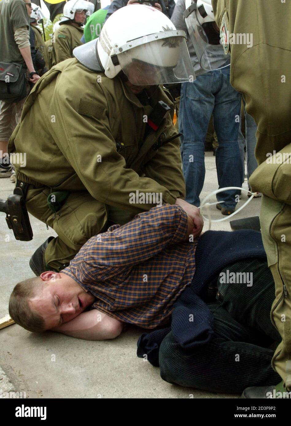 German riot police arrests a neo-Nazi during May Day demonstration by the German far-right National Democratic Party (NPD) in Berlin May 1, 2004. [Some 2.000 NPD members took part in a demonstration in Berlin on Saturday, with left-wing counter-demonstrators trying to stop the march.] Stock Photo