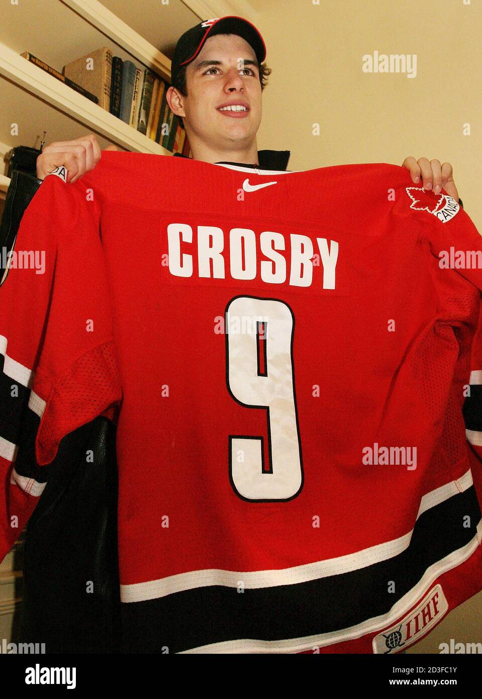 Sidney Crosby holds up his Team Canada jersey during a press conference in  Halifax, Nova Scotia on January 13, 2005. The jersey was recovered after  being stolen from his luggage during his