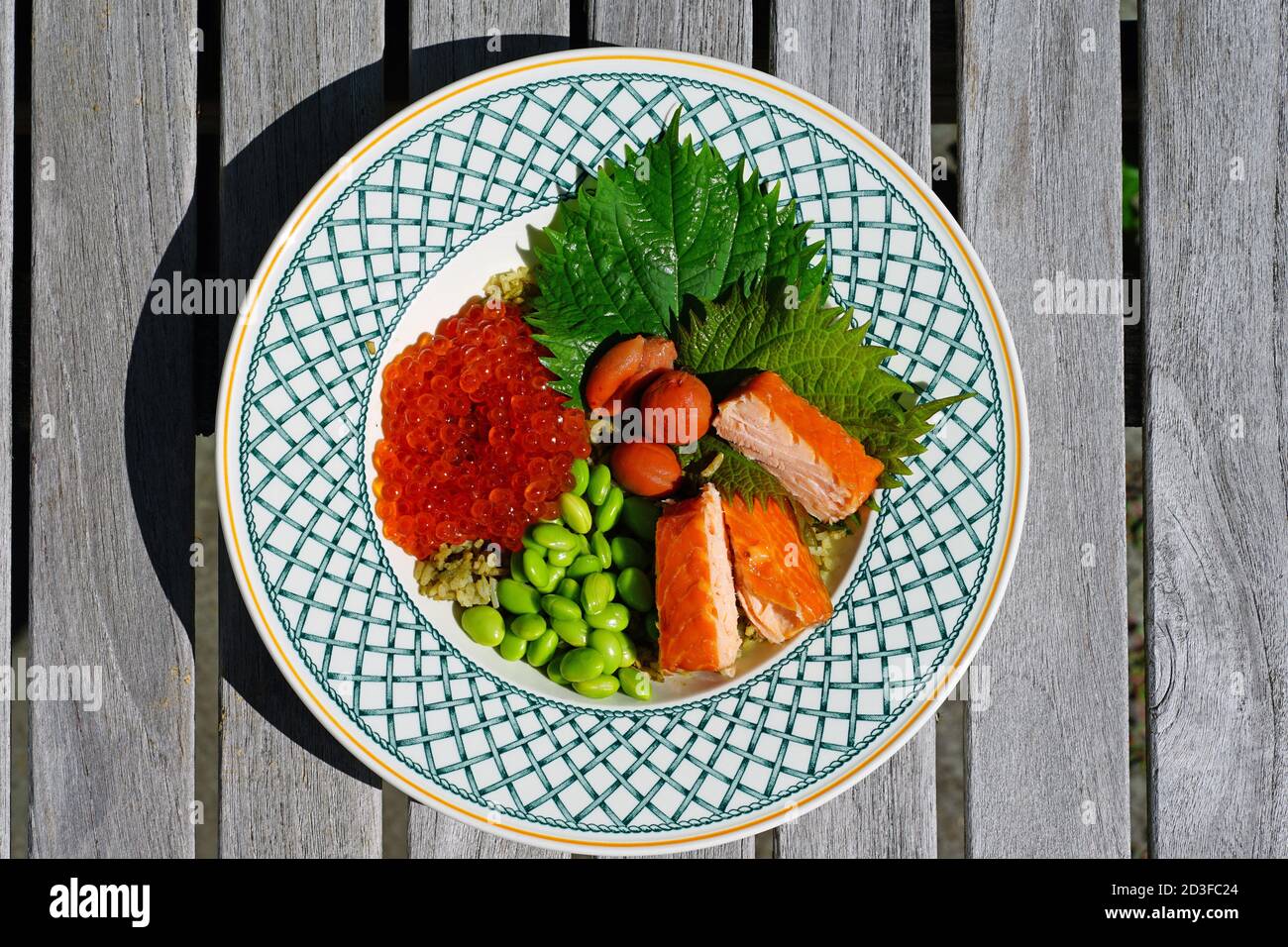 Asian green rice bowl with salmon roe, salmon, edamame, shiso leaf and