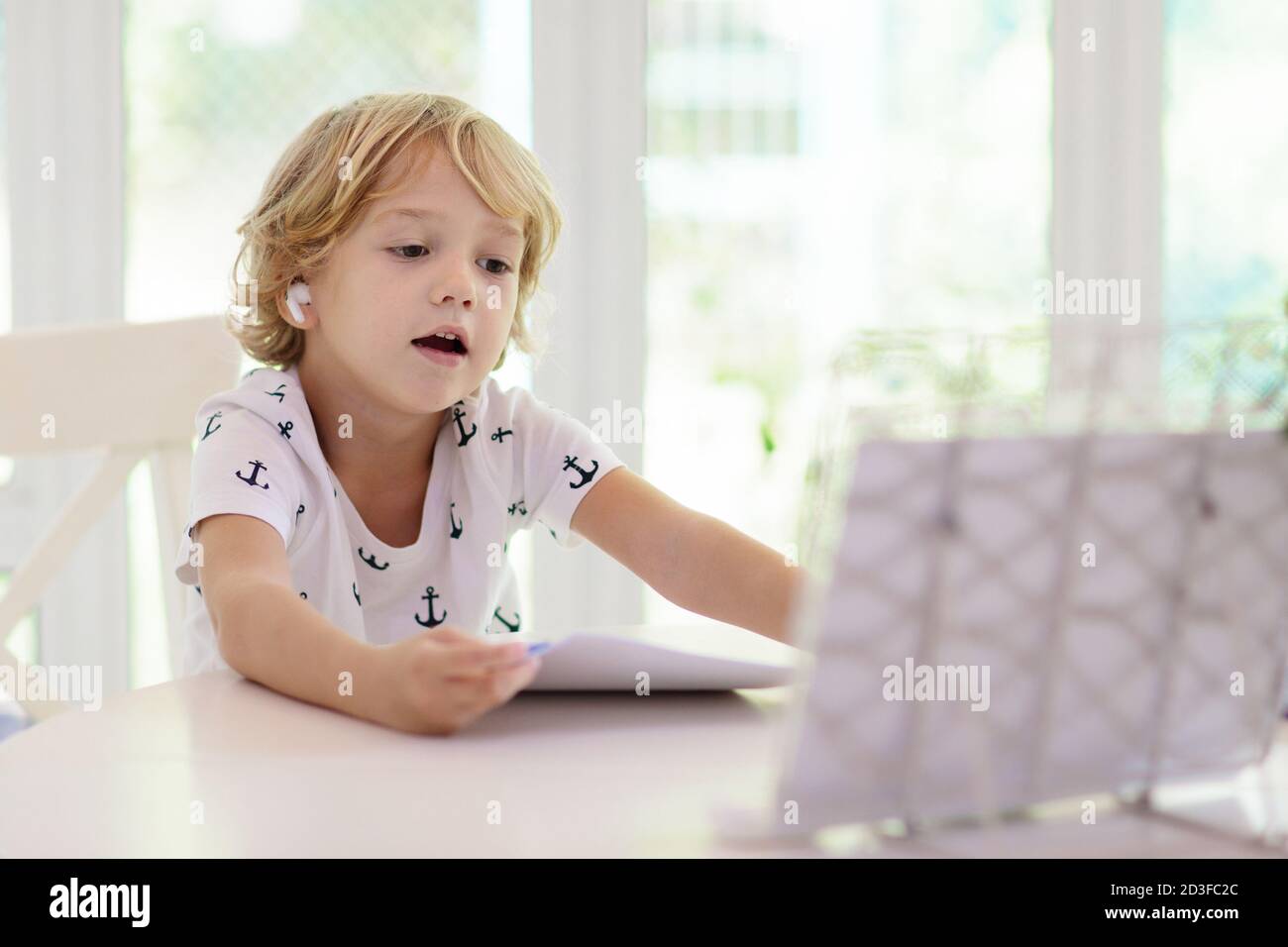 Online remote learning. School kids with computer having video ...