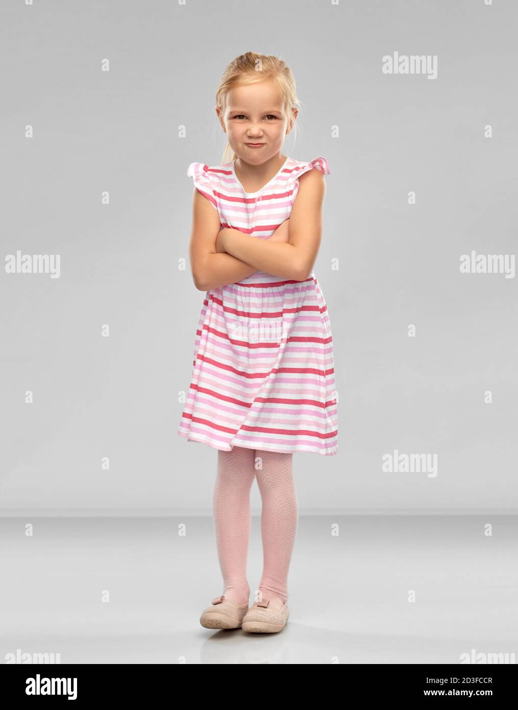 displeased little girl with crossed arms pouting Stock Photo Alamy