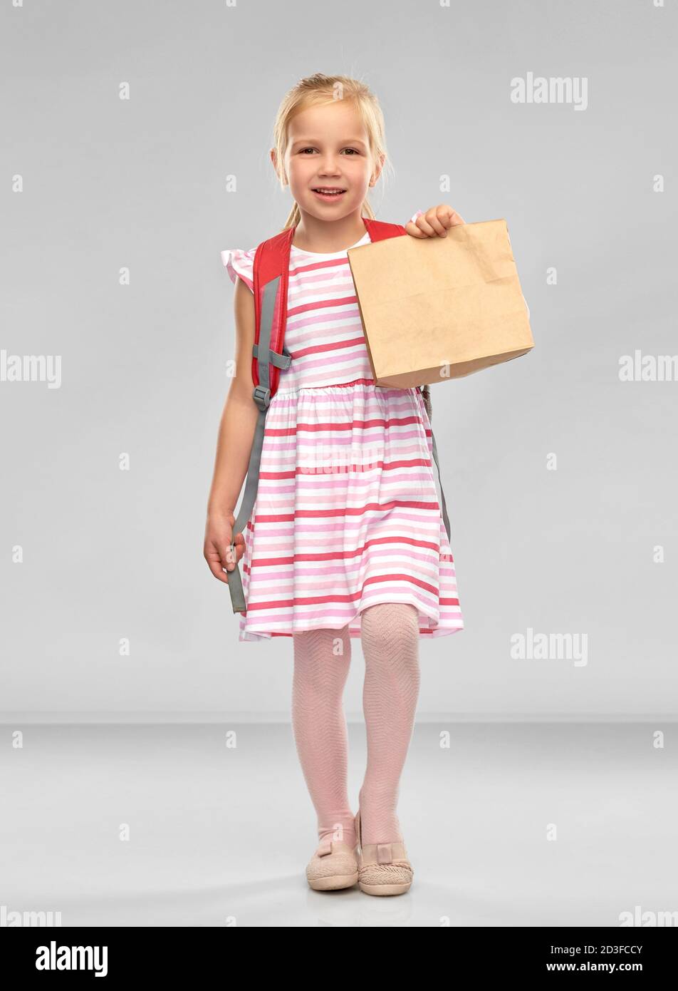 little student girl with school lunch in paper bag Stock Photo - Alamy