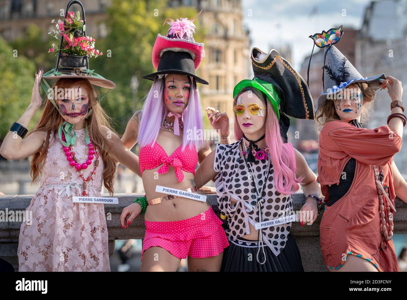 Models take part in a colourful flashmob street fashion show in Trafalgar Square for designer Pierre Garroudi. London, UK. Stock Photo