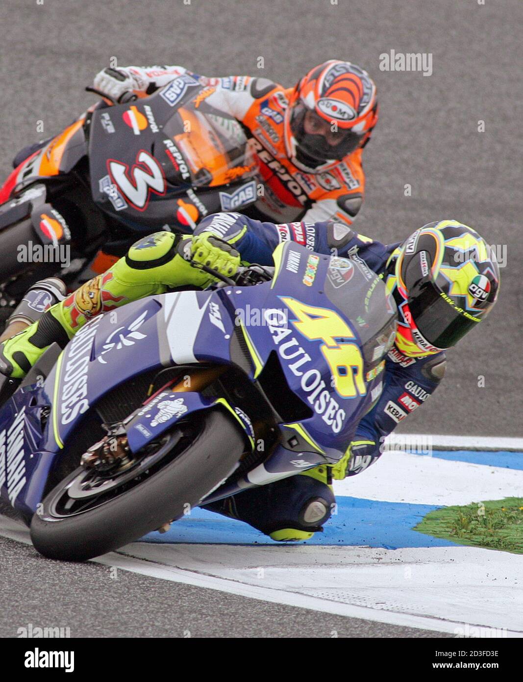 Italy's Valentino Rossi (R) on a MotoGP Yamaha and Max Biaggi (L) on a  MotoGP Honda take a curve during the Portugal's Grand Prix in Estoril April  17, 2005. Brazil's Alex Barros