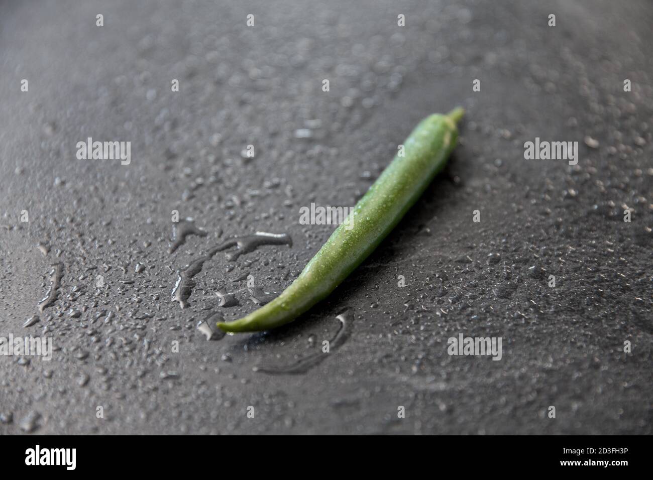 green chili pepper on slate stone background Stock Photo