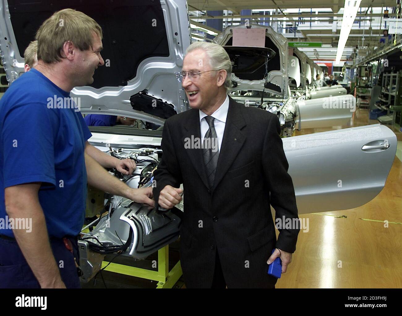 Juergen Hubbert Member Of The Board Of Daimler Chrysler Chats With A Worker On The Production Line Of The New Mercedes Benz Sl 500 Roadster During A Visit At The Car Plant